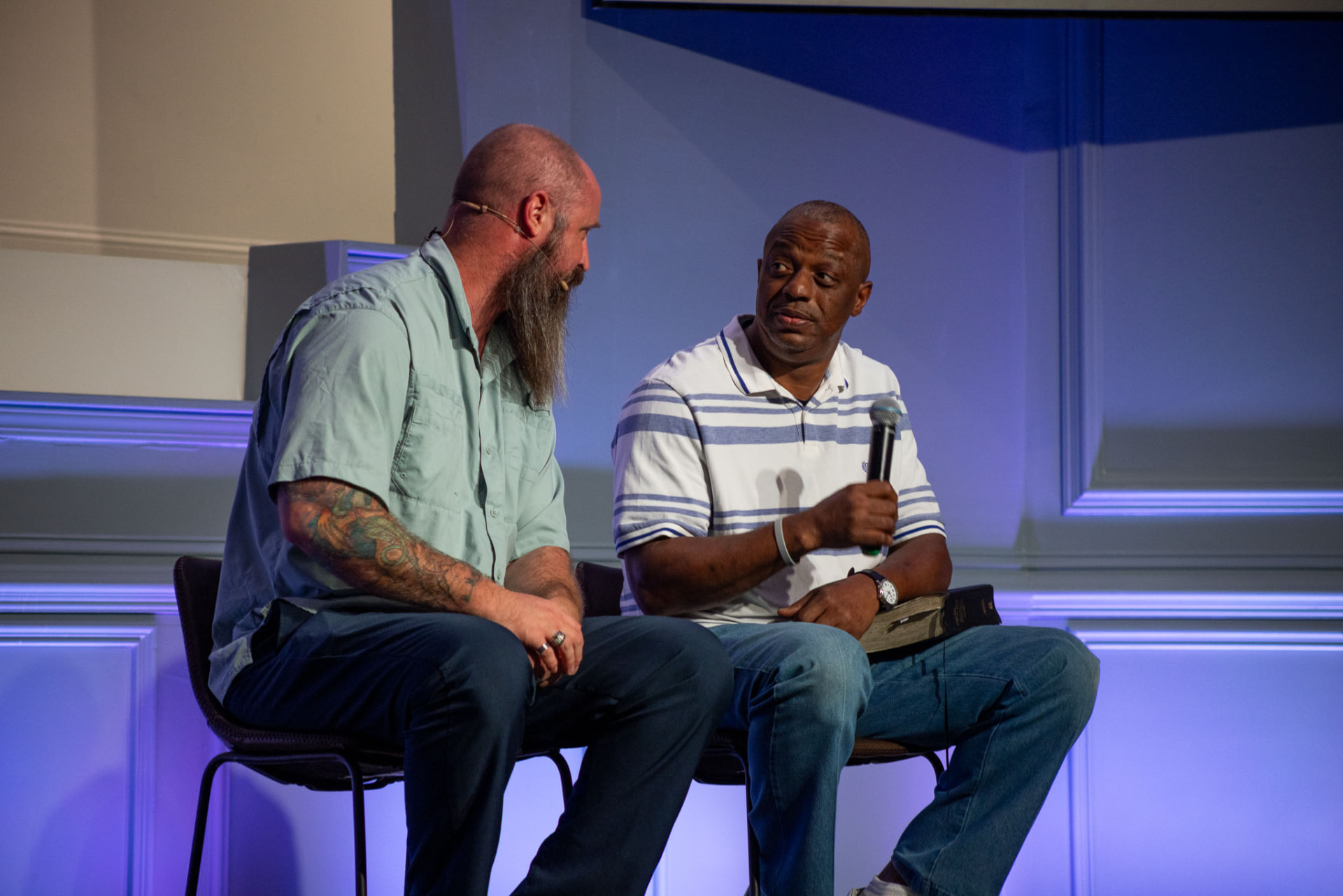 Two church members talking over coffee in the church lobby